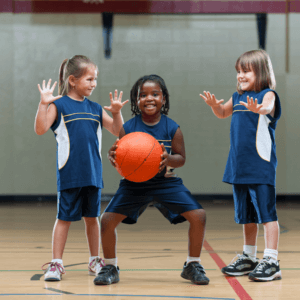 Young children playing basketball