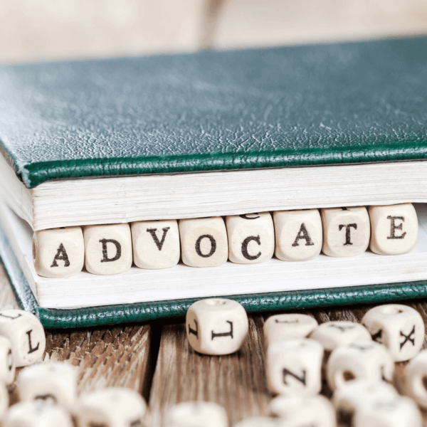 Edge of a book with the word "ADVOCATE" spelled out in small blocks